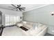 Cozy living room featuring a plush sectional sofa, large windows, and an elegant ceiling fan at 320 Conch Key Way, Sanford, FL 32771