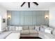 Bright living room with a large sectional sofa, decorative pillows, and stylish wall sconces at 320 Conch Key Way, Sanford, FL 32771