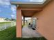 Covered patio with comfortable seating and view of the backyard at 320 Conch Key Way, Sanford, FL 32771