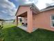 Relaxing covered patio with chairs overlooking the well-maintained lawn and fence at 320 Conch Key Way, Sanford, FL 32771