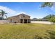 Large backyard with a well-manicured lawn, white fence and an enclosed patio area at 3333 Atmore Ter, Ocoee, FL 34761