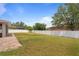 Spacious backyard featuring lush grass, a privacy fence, and a brick-paved patio at 3333 Atmore Ter, Ocoee, FL 34761