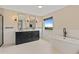 Modern bathroom features a soaking tub, dual vanity with dark cabinetry, and bright tile floors at 3333 Atmore Ter, Ocoee, FL 34761
