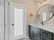 Bathroom with dark cabinetry, quartz countertop, and modern fixtures near glass shower at 3333 Atmore Ter, Ocoee, FL 34761