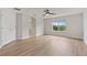 Bedroom with light vinyl flooring and a view of the exterior trees at 3333 Atmore Ter, Ocoee, FL 34761
