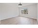 Bedroom with a window overlooking a residential neighborhood, light walls and wood flooring at 3333 Atmore Ter, Ocoee, FL 34761