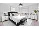 Staged bedroom features a plush bed, stylish furniture, neutral tones, and a bright window at 3333 Atmore Ter, Ocoee, FL 34761