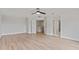 Spacious bedroom with hardwood floors, ceiling fan, and an open doorway to other areas of the home at 3333 Atmore Ter, Ocoee, FL 34761
