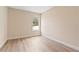 Bright bedroom with neutral walls and wood floors, centered with a single window at 3333 Atmore Ter, Ocoee, FL 34761