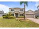 Charming two-story home featuring a well-manicured lawn, lush landscaping, and a two-car garage at 3333 Atmore Ter, Ocoee, FL 34761