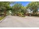Secured community gate with brick pillars, mature trees, and well-maintained landscaping at 3333 Atmore Ter, Ocoee, FL 34761