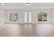 Spacious living room with beautiful french doors, windows, and light vinyl floors at 3333 Atmore Ter, Ocoee, FL 34761