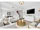 Cozy living room with plush sofas, a round gold coffee table, and ample natural light at 3333 Atmore Ter, Ocoee, FL 34761