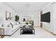 Bright living room featuring a comfortable L-shaped sofa, modern art, and a sleek black coffee table at 3333 Atmore Ter, Ocoee, FL 34761