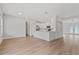 Open-concept living room with wood-look flooring and a seamless flow to the kitchen at 3333 Atmore Ter, Ocoee, FL 34761
