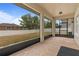 Screened in patio with geometric tiling and a view of the spacious backyard at 3333 Atmore Ter, Ocoee, FL 34761