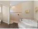 A modern bathroom with wood-look floors, a glass-enclosed shower, and a separate soaking tub at 3470 Tesoro Cir, New Smyrna Beach, FL 32168
