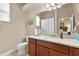 This cozy bathroom boasts granite countertops, a cherry vanity, and a shower with a tub at 3470 Tesoro Cir, New Smyrna Beach, FL 32168
