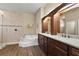 A luxurious bathroom with tile floors, a tiled shower, a soaking tub, and double sinks at 3470 Tesoro Cir, New Smyrna Beach, FL 32168