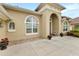 Inviting home entryway with elegant arched windows and brick-paver walkway at 3470 Tesoro Cir, New Smyrna Beach, FL 32168