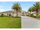 Beautiful single-story home with well-manicured lawn and a long driveway at 3470 Tesoro Cir, New Smyrna Beach, FL 32168