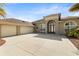 Stunning single-story home featuring a 3-car garage, arched windows, and a spacious concrete driveway at 3470 Tesoro Cir, New Smyrna Beach, FL 32168