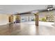 A spacious three-car garage with tile floors, offering parking and extra storage space at 3470 Tesoro Cir, New Smyrna Beach, FL 32168