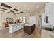 Kitchen with an island and a view into a dining and living area, coffered ceilings at 3470 Tesoro Cir, New Smyrna Beach, FL 32168
