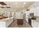 Bright kitchen featuring a center island, stone countertops, and modern appliances at 3470 Tesoro Cir, New Smyrna Beach, FL 32168