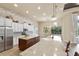 Well-equipped kitchen with stainless appliances, stone accent wall, and stone countertops at 3470 Tesoro Cir, New Smyrna Beach, FL 32168