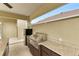 Covered outdoor kitchen has stainless grill, mini-fridge and counter space at 3470 Tesoro Cir, New Smyrna Beach, FL 32168
