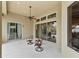 Covered patio with ceiling fan and views of the backyard at 3470 Tesoro Cir, New Smyrna Beach, FL 32168