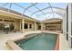 Relax in the screened pool and enjoy the outdoor kitchen at 3470 Tesoro Cir, New Smyrna Beach, FL 32168