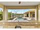 Inviting outdoor pool area offering screened enclosure, water feature, and lush landscaping at 3470 Tesoro Cir, New Smyrna Beach, FL 32168
