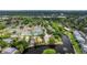 Charming community aerial view features a lake with fountains, tennis courts and lush landscaping at 38 Lake Walden Trl, Ormond Beach, FL 32174