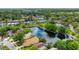 Expansive aerial view of the community featuring lush greenery, a serene pond, and well-maintained residential properties at 38 Lake Walden Trl, Ormond Beach, FL 32174