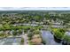 An aerial view of a vibrant community featuring a tranquil pond and well-maintained tennis courts at 38 Lake Walden Trl, Ormond Beach, FL 32174