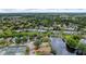 An aerial view of a vibrant community featuring a tranquil pond and well-maintained tennis courts at 38 Lake Walden Trl, Ormond Beach, FL 32174