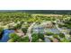 Community aerial showcasing a peaceful pond with fountains, tennis courts and lush greenery at 38 Lake Walden Trl, Ormond Beach, FL 32174