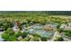 Scenic aerial view of the community showing a pond, tennis courts, and verdant landscaping at 38 Lake Walden Trl, Ormond Beach, FL 32174
