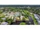 Charming community aerial view features a lake with fountains, tennis courts and lush landscaping at 38 Lake Walden Trl, Ormond Beach, FL 32174