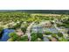 Community aerial showcasing a peaceful pond with fountains, tennis courts and lush greenery at 38 Lake Walden Trl, Ormond Beach, FL 32174