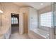 Bathroom featuring dual sinks, a large mirror, a glass shower, and a soaking tub at 38 Lake Walden Trl, Ormond Beach, FL 32174