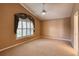 This room boasts neutral walls, a ceiling fan, carpet, and a window at 38 Lake Walden Trl, Ormond Beach, FL 32174