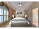Cozy bedroom featuring a large window and plush bed at 38 Lake Walden Trl, Ormond Beach, FL 32174