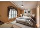 Comfortable bedroom features large window with shutter shade and a plush bed at 38 Lake Walden Trl, Ormond Beach, FL 32174