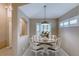 Cozy dining area with a round table and shuttered windows at 38 Lake Walden Trl, Ormond Beach, FL 32174