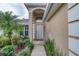 Inviting home entrance framed by lush, tropical landscaping at 38 Lake Walden Trl, Ormond Beach, FL 32174