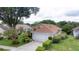 Well-manicured lawn surrounds this home, which features a spacious driveway at 38 Lake Walden Trl, Ormond Beach, FL 32174