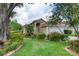 Charming home featuring a well-manicured lawn and lush landscaping at 38 Lake Walden Trl, Ormond Beach, FL 32174